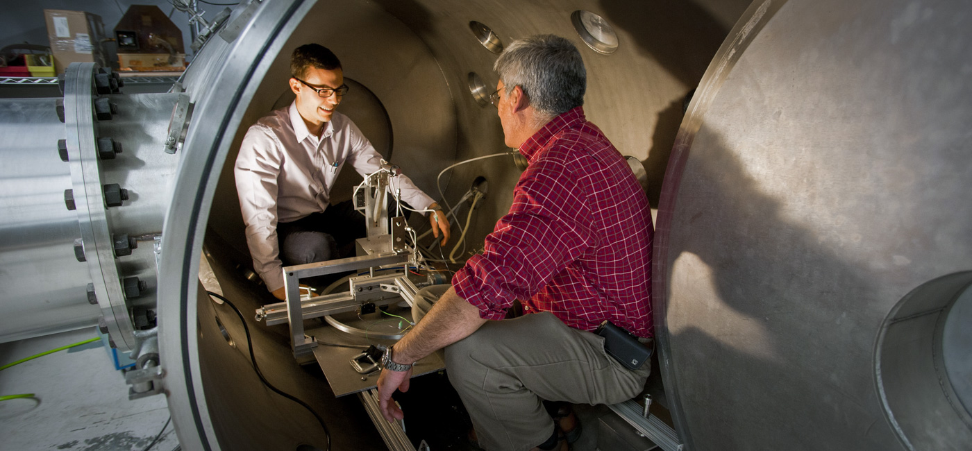 Student and a professor walking in the lab