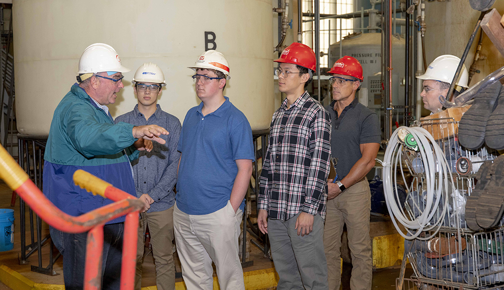 Participating in waste remediation plant tour as part of the project field work.