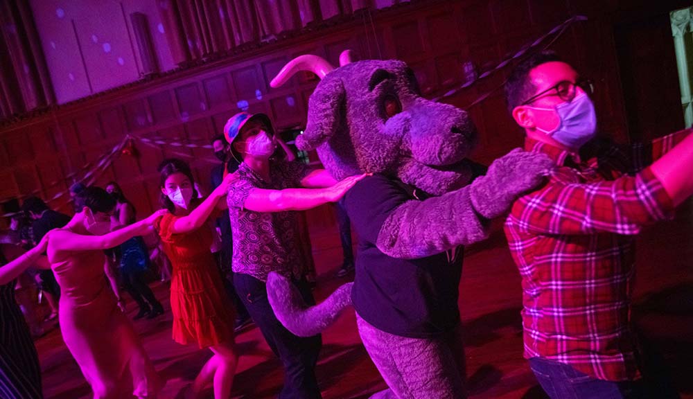 Students form a conga line with Gompei during a Valentine’s Day dance.