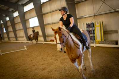Equestrian student riding on the back of a horse