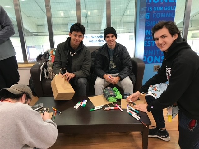 Tau Kappa Epsilon members pulling together emergency kits for foster care children.