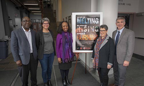 WPI faculty members standing with sustainability sign