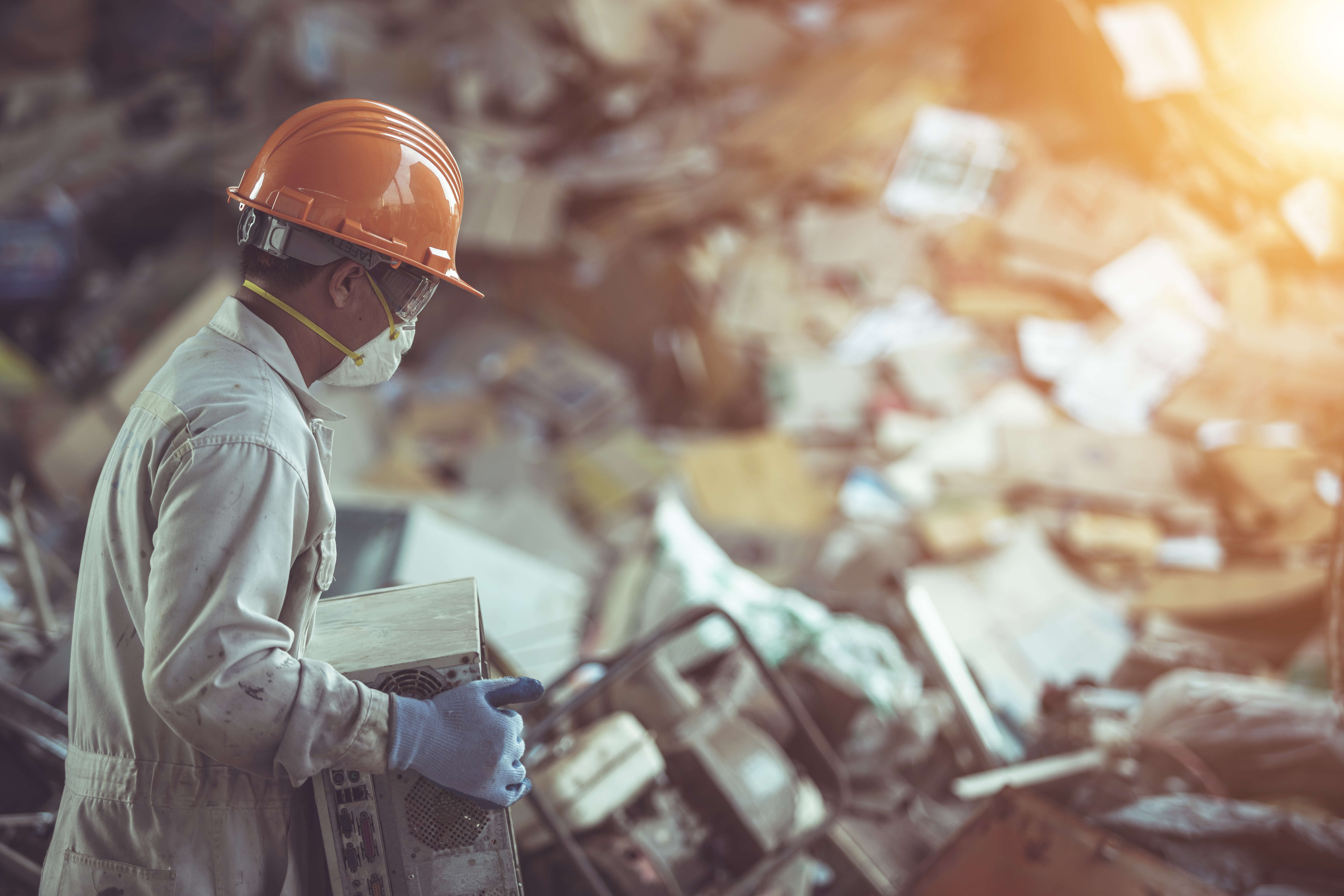 Researcher surveys pile of metal parts