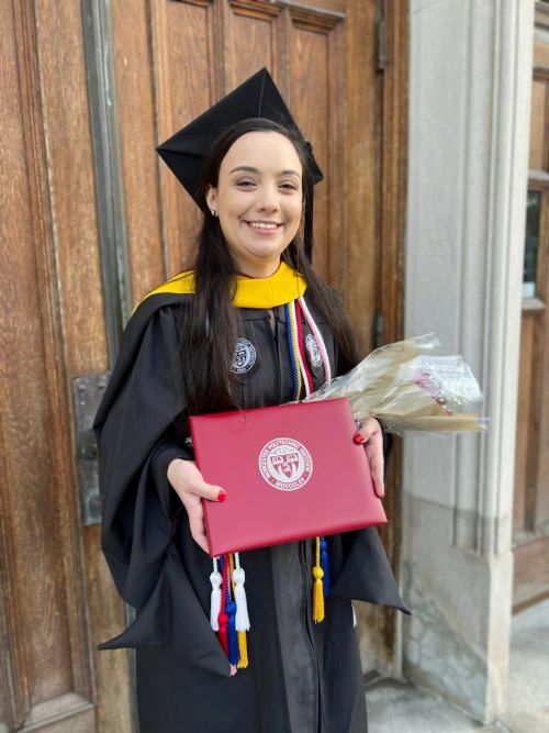 female student in graduate commencement regalia, black cap and gown
