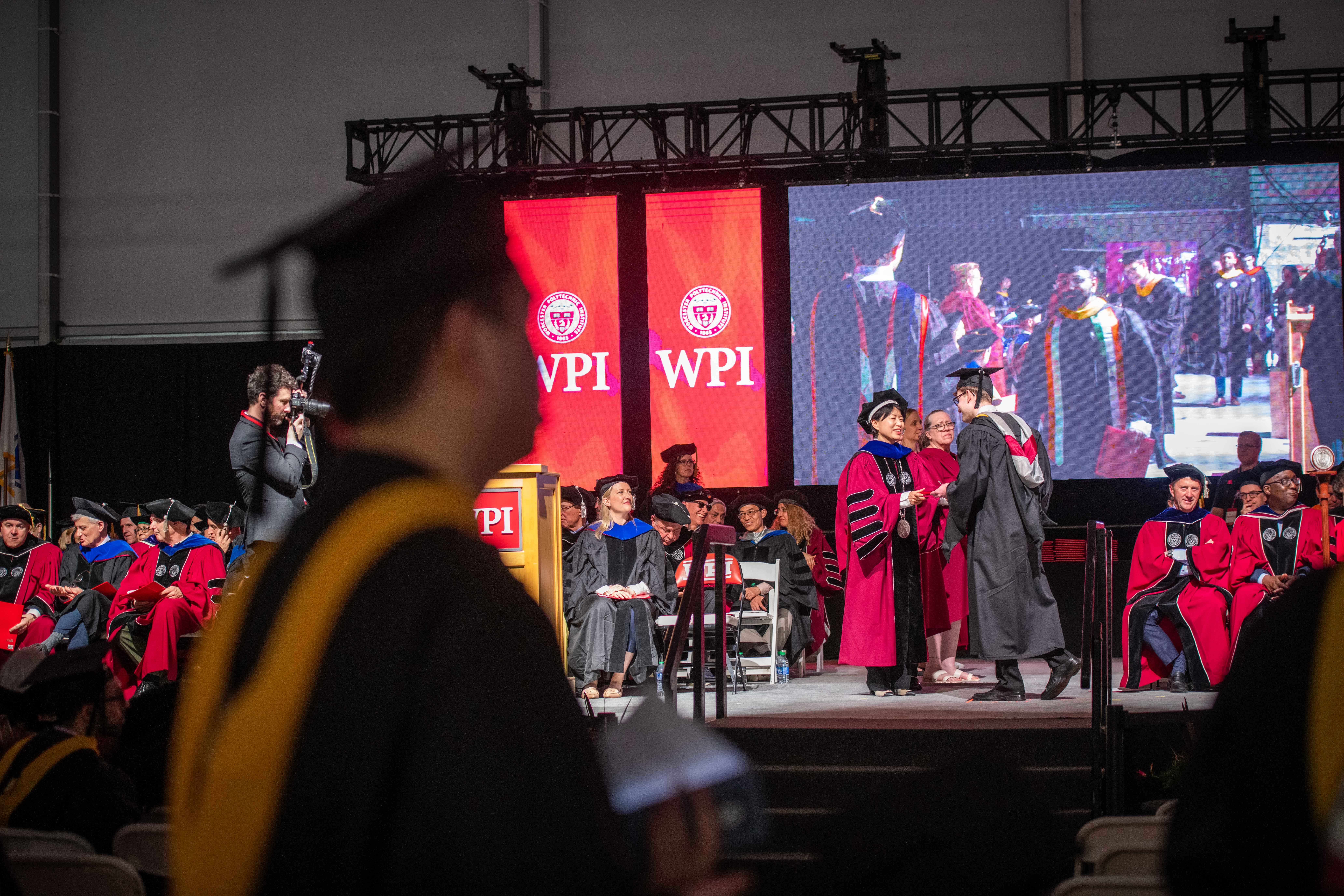 Graduates on stage getting diplomas