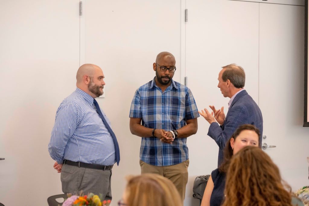 Matt Barry, Arnold Lane, and Charles Morse chatting at the Board of Trustees Outstanding Staff Awards luncheon