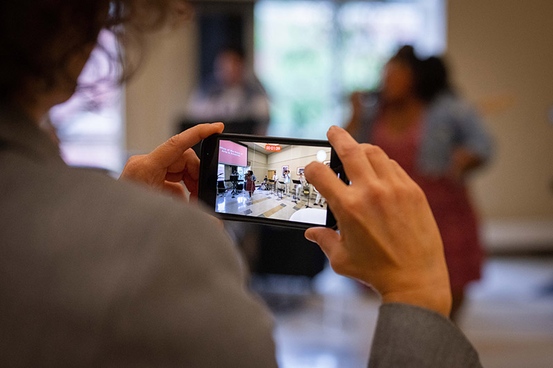Student taking a video for social media.