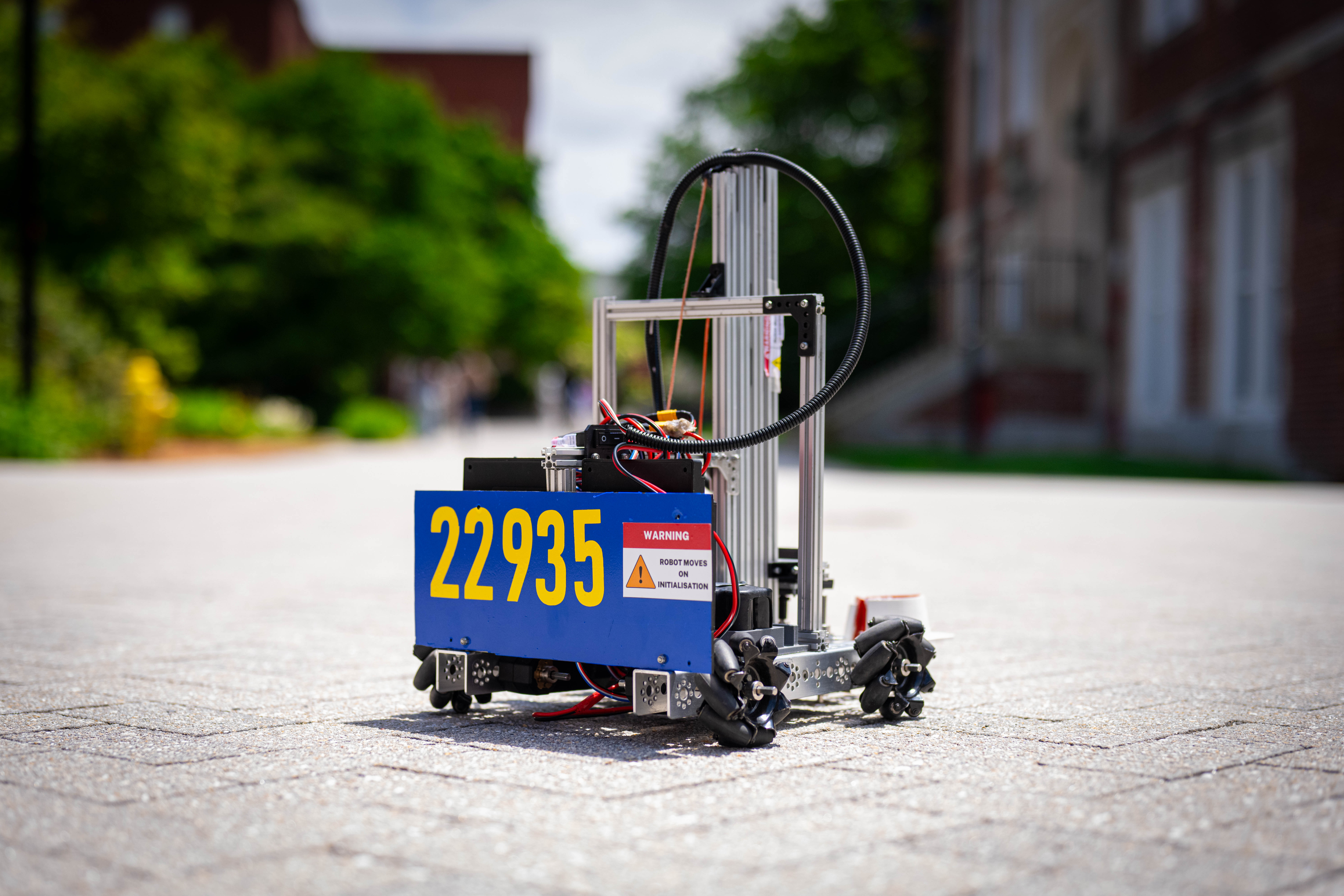 A robot the Galactic Einsteins brought to WPI sits outside the Rubin Campus Center. The team programs robots to lift and transport items