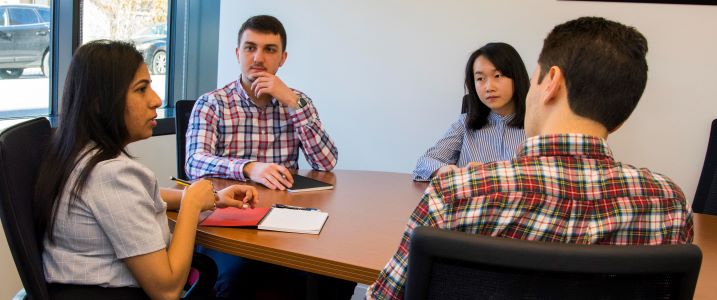 students talking around a desk