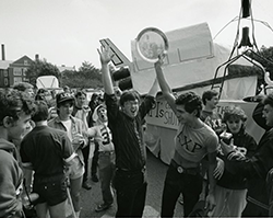 Two students celebrate in a crowd at Homecoming