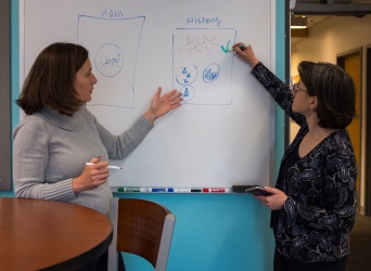 At the whiteboard, Tulu and Ruiz explore enhancements to the SlipBuddy app, which could be ready for release as early as 2019.