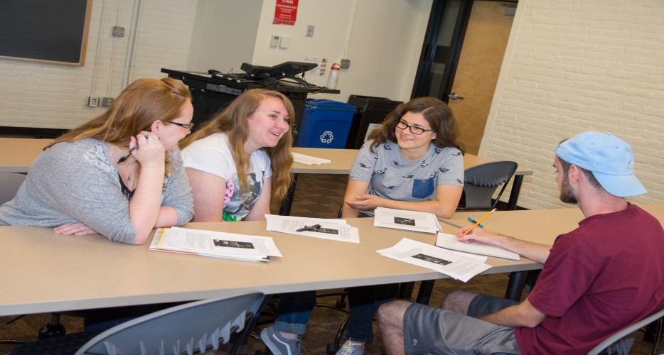 Students work on a project together in a classroom.