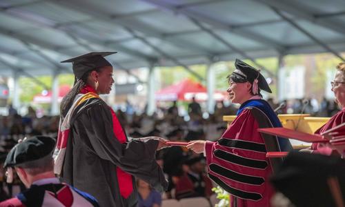 student receiving diploma at commencement
