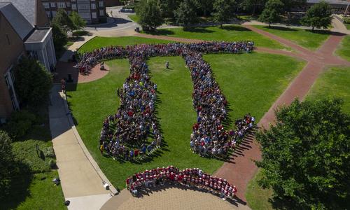 students forming the Pi symbol on quad