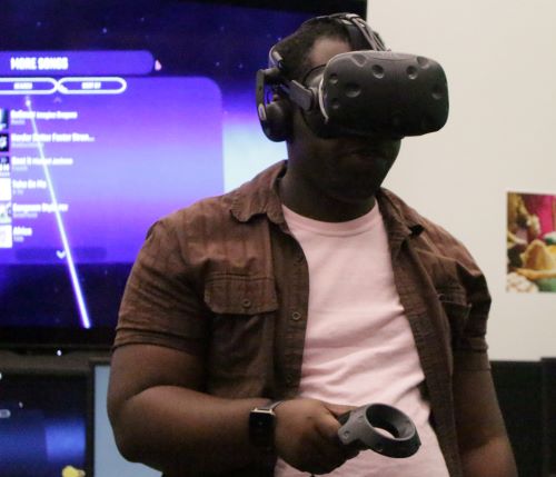 a male using a virtual reality headset