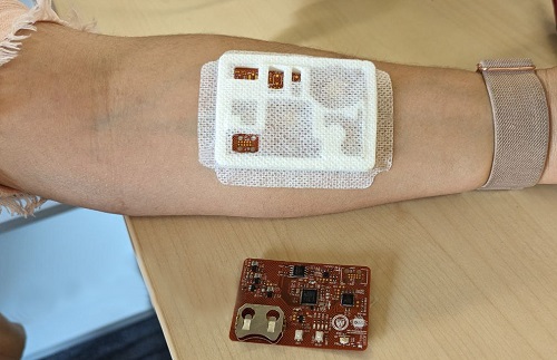 A prototype oxygen sensor about the size of a bandage on an arm