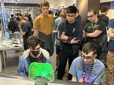 Students play video games at launch event for WPI library exhibit