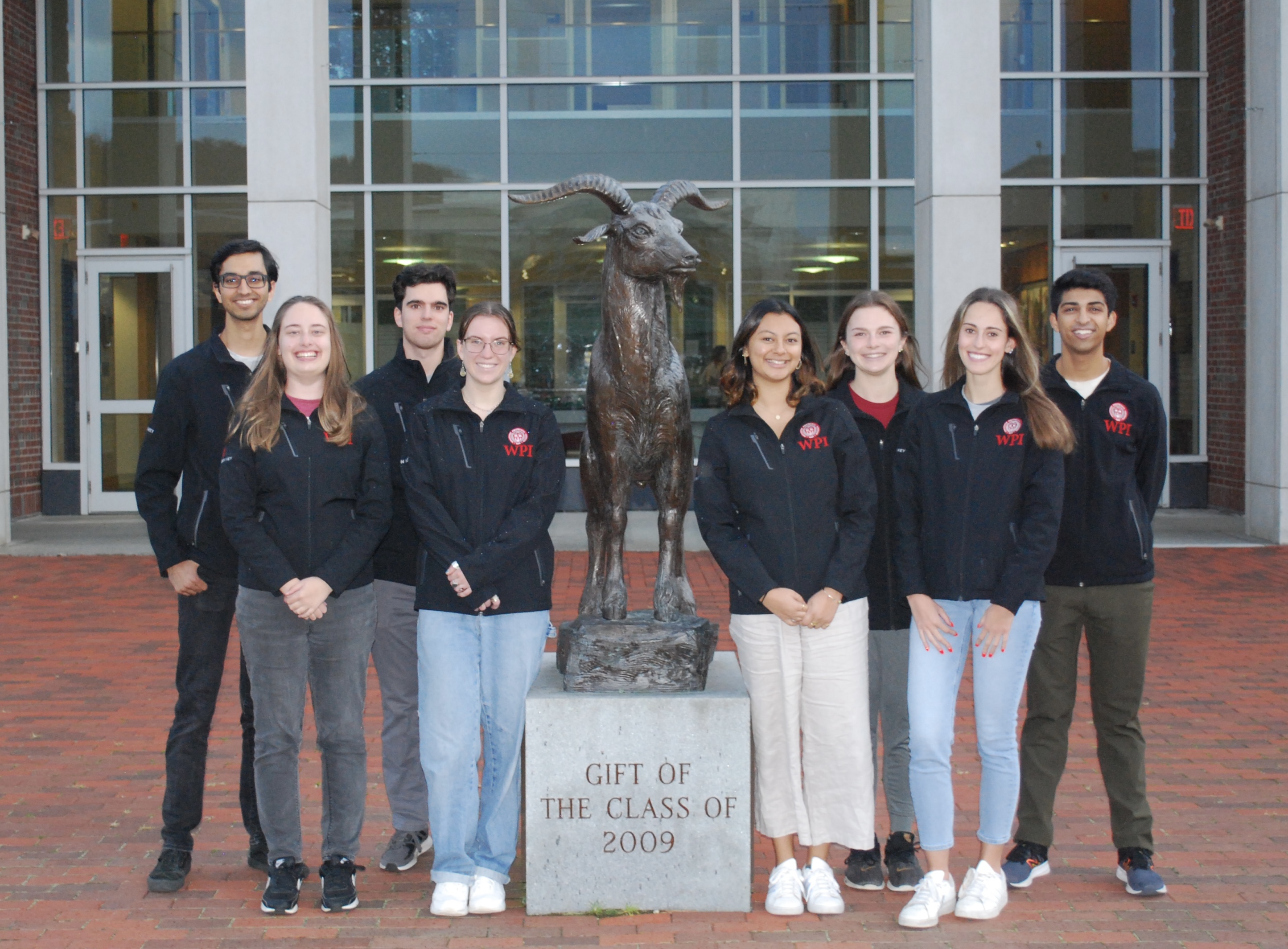 WPI’s Crimson Key Tour Guides standing in front of the Gompei Statue