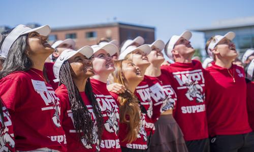 a group of students standing in a line looking up