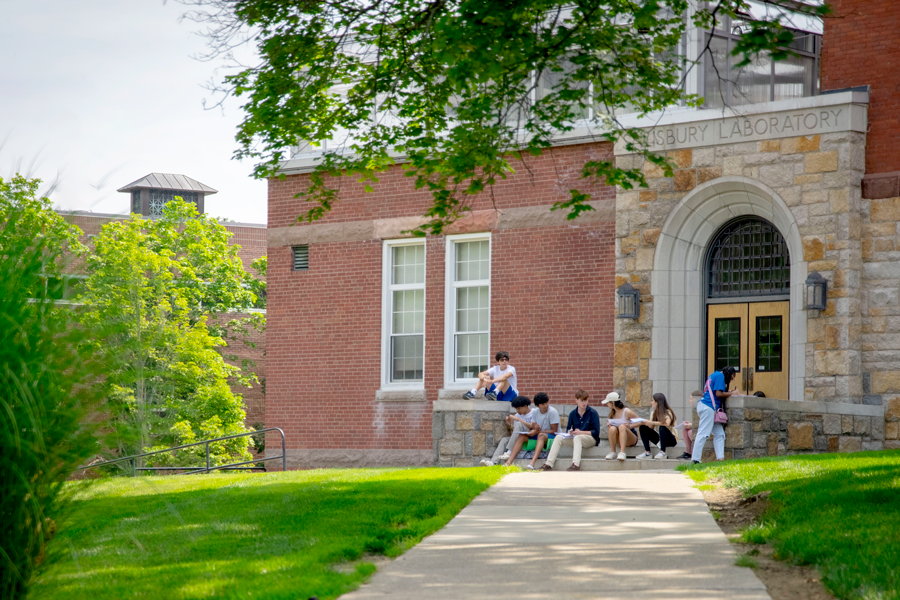 Students sit outside during summer classes