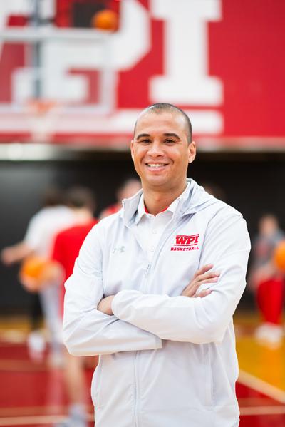 David Brown standing on a basketball court with his arms crossed