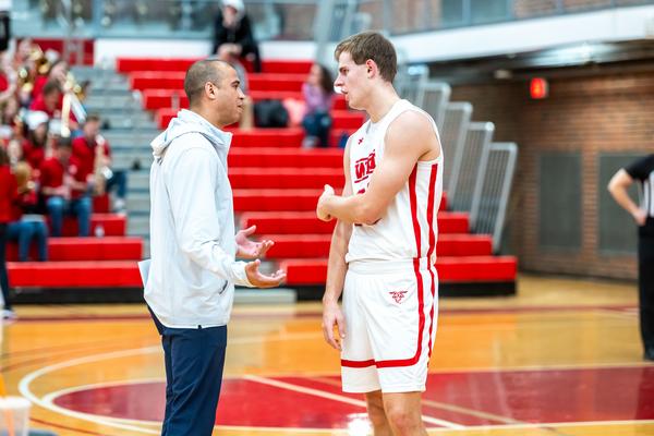 David Brown talking to one of his players on the basketball court