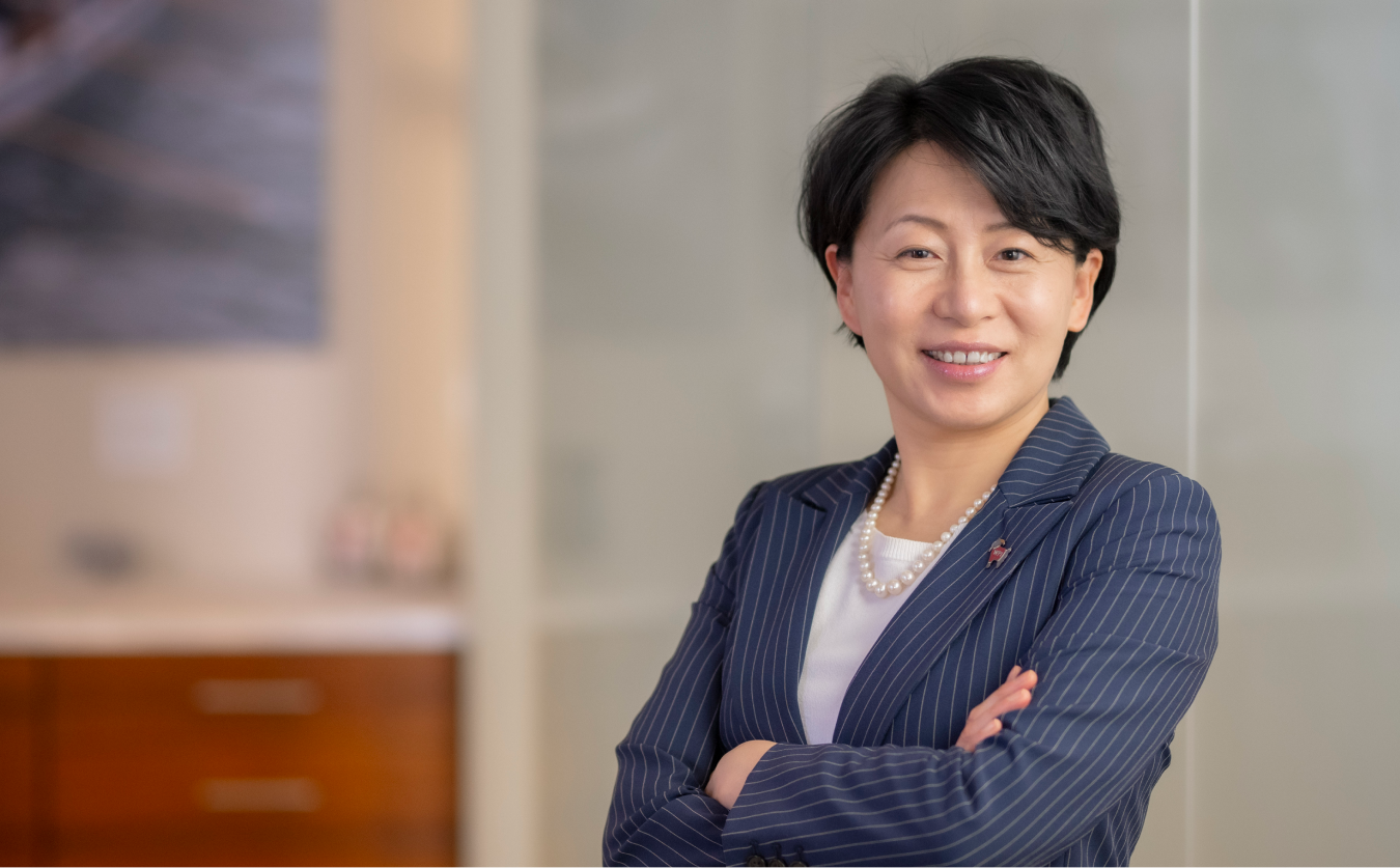 President Grace Wang smiles in her office.