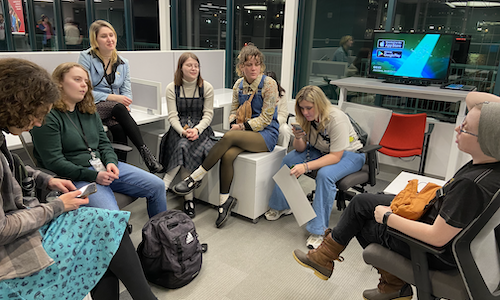 A group of IMGD arts students listen to advice from an industry professional.