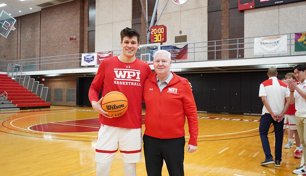 John Adams ’24 with the head men’s basketball coach following his 1,000-point milestone.