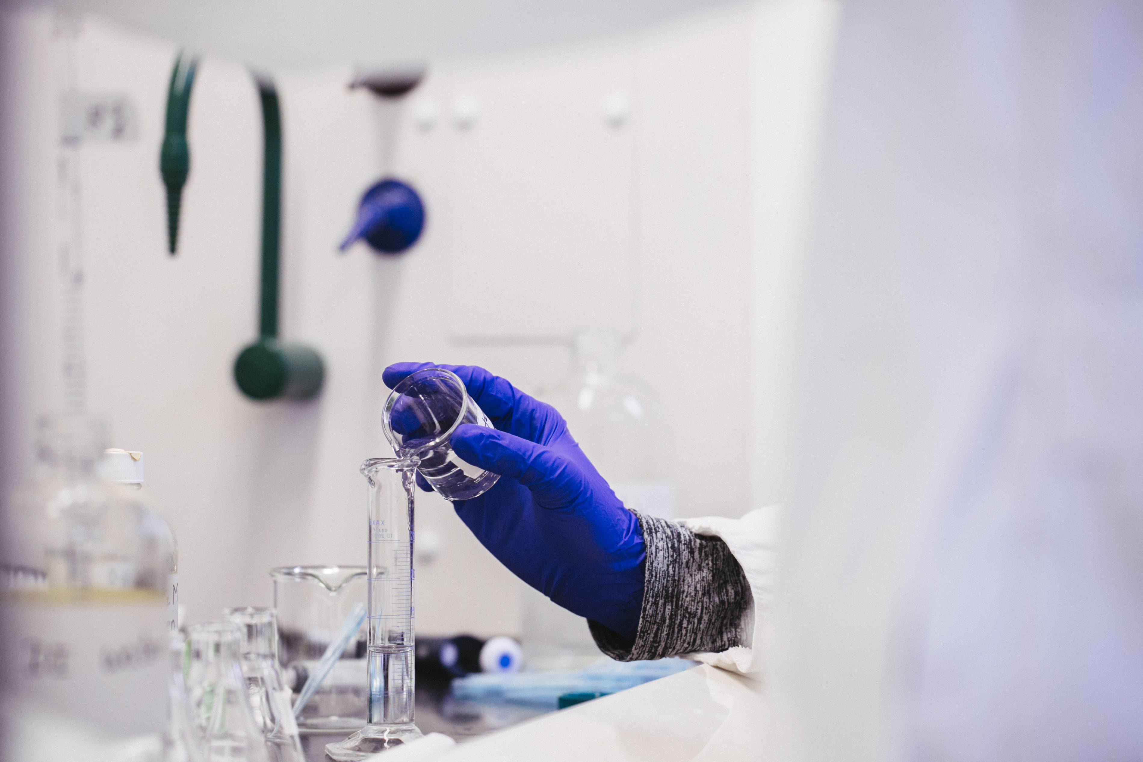 Hand holding test tube.