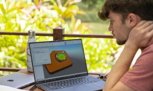student looks at computer model of a garden design