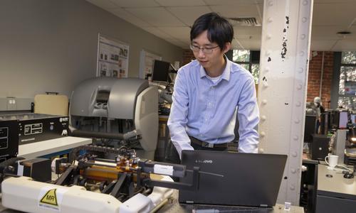 WPI Professor Haichong (Kai) Zhang works with an MRI device in his lab in the Life Sciences and Biotechnology Center (LSBC).