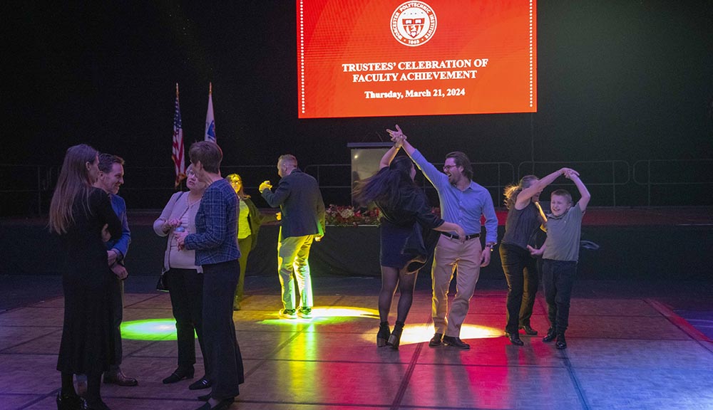 Attendees dance during the faculty achievement dinner celebration.