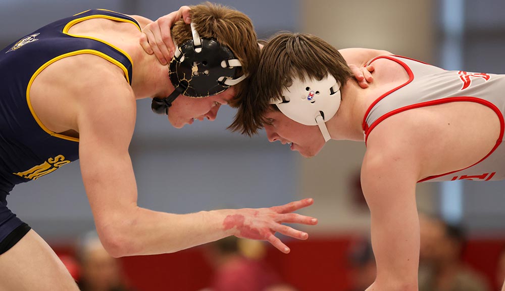 Two student wrestlers prepare for a match.