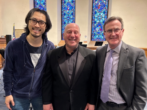Binan Gu, Mitchell Lutch, and Thomas O’Toole pose for photo inside concert hall at Worcester Area Mission society