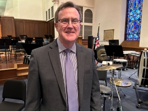 Thomas O’Toole stands in hall at Worcester Area Mission Society following concert performance