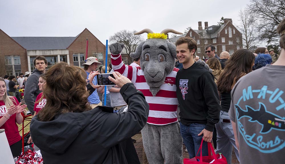A prospective student takes a photo with Gompei during Accepted Student Day.