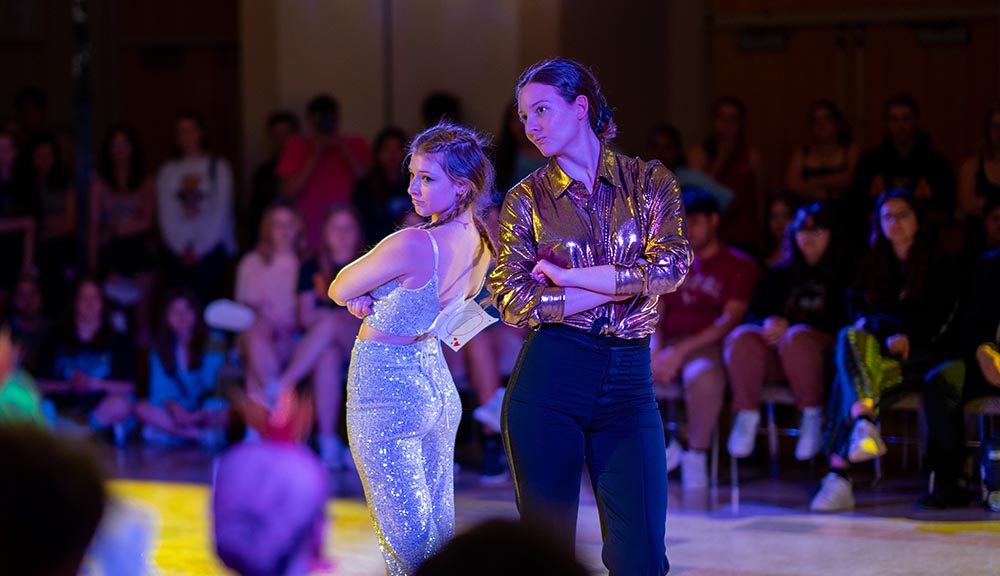 Students participate in Greek Week during a dance event.