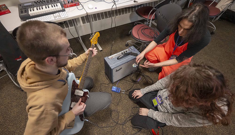 An aerial photo of students playing guitar.