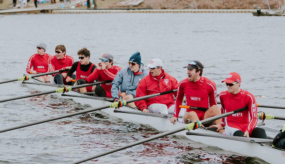 Members of the men’s rowing team cheer each other on while out on the water.