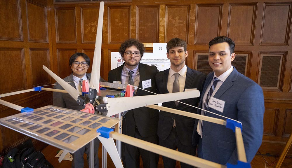 Students pose with a project of theirs during a presentation on campus.