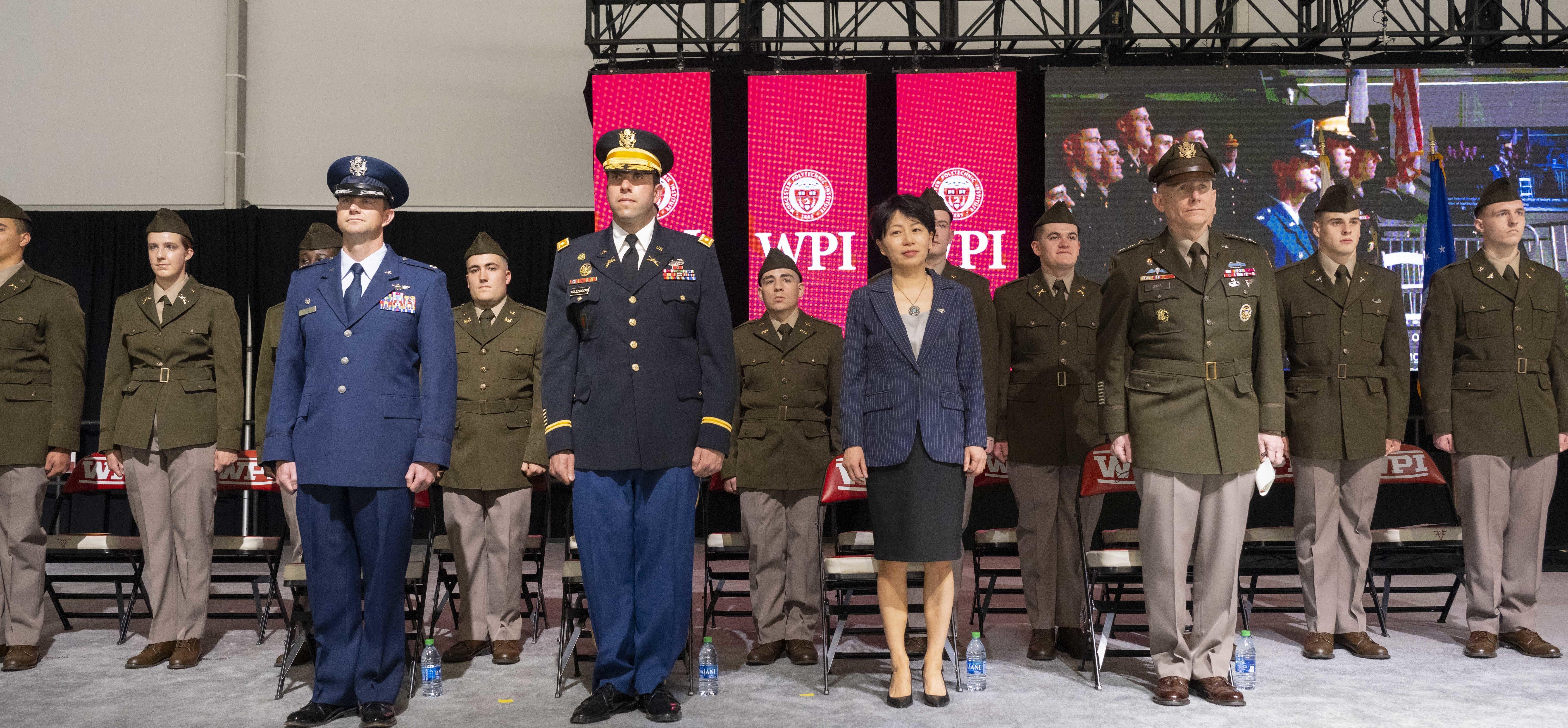Attendees at the ROTC commissioning ceremony applaud for the new recruits.