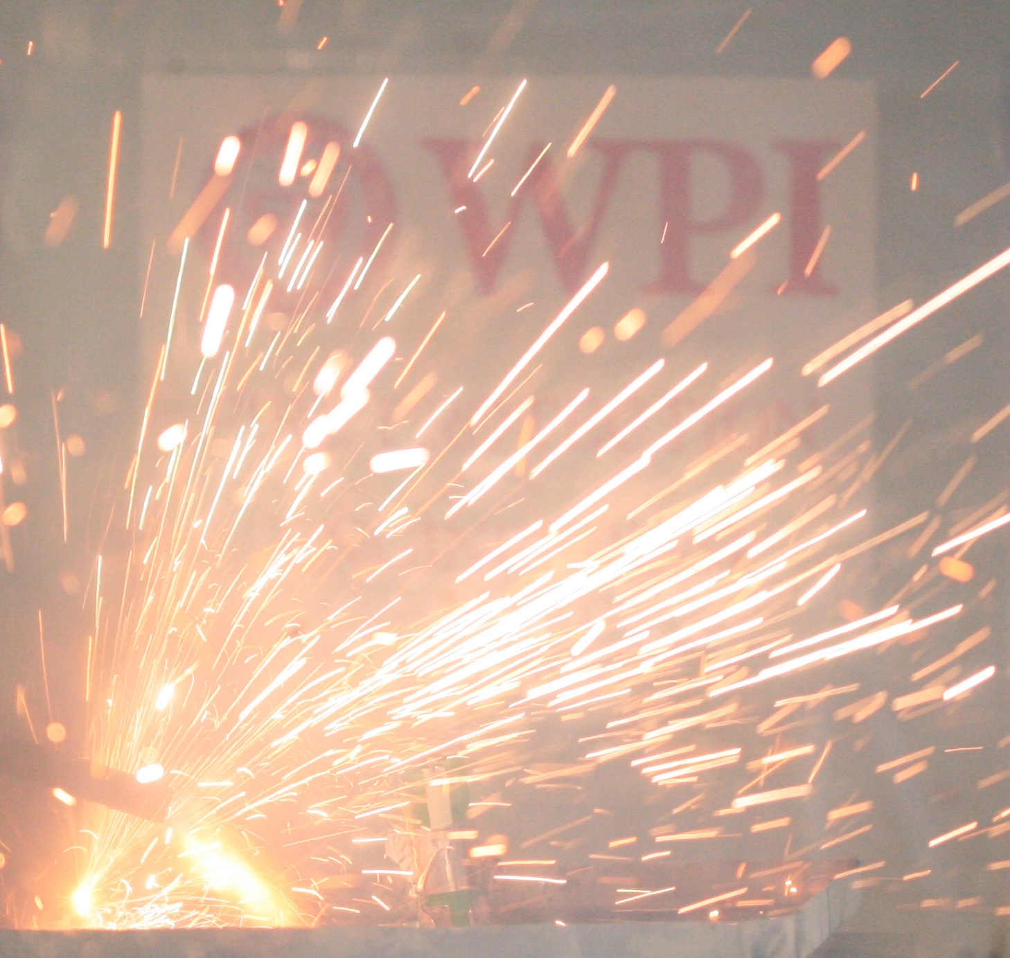 A lithium-ion battery explodes with the WPI logo in the background