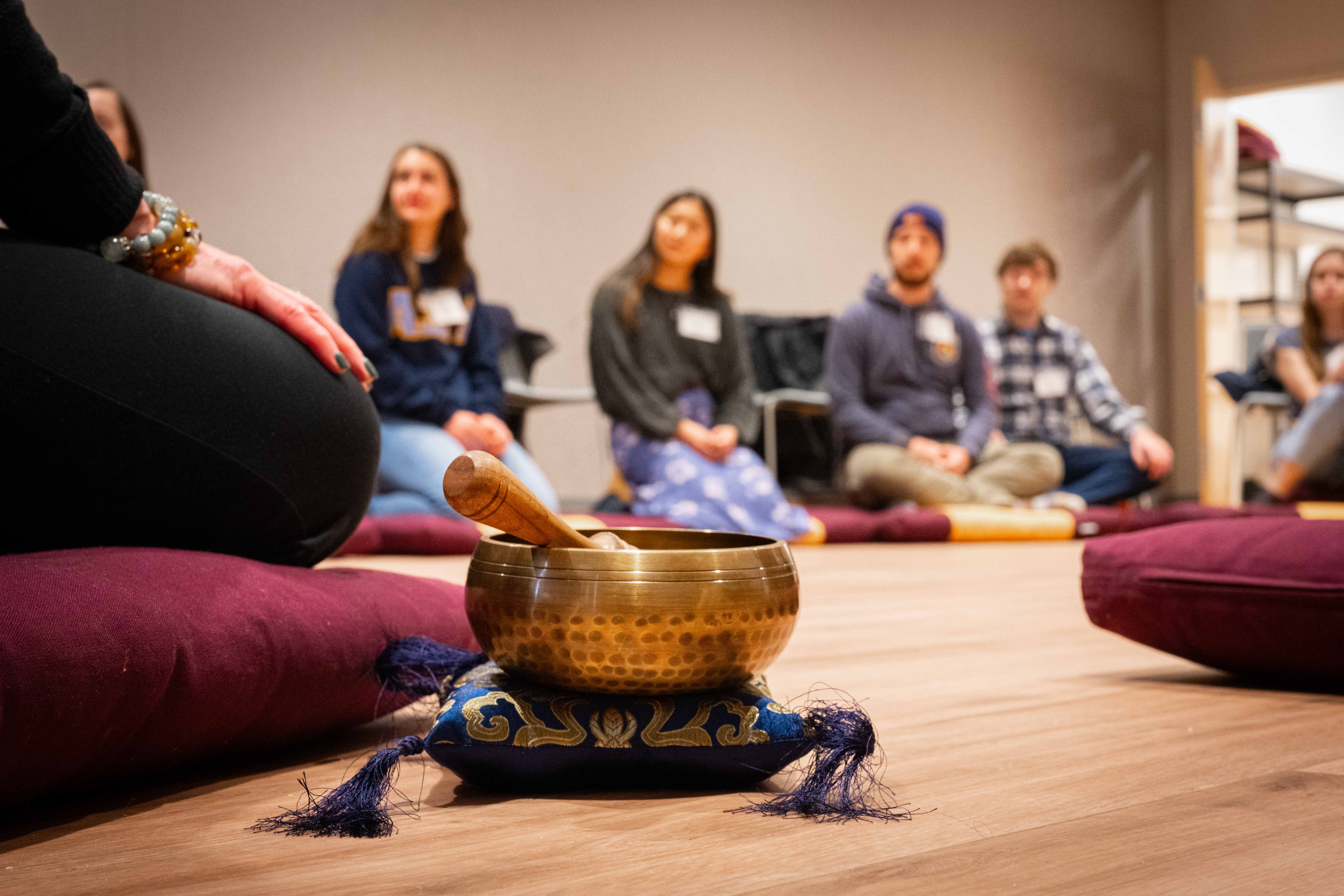 singing bowl with meditating people