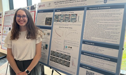 student presenting research on a poster