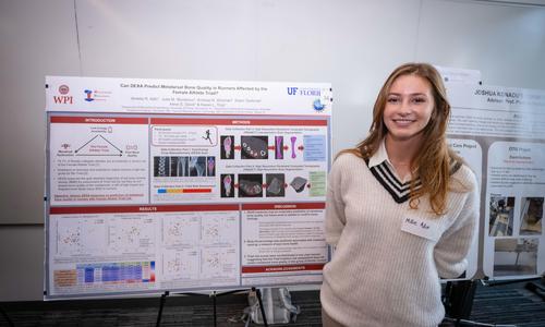 student presenting research on a poster