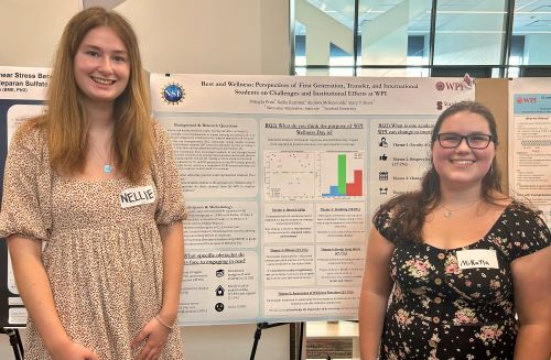 student presenting research on a poster