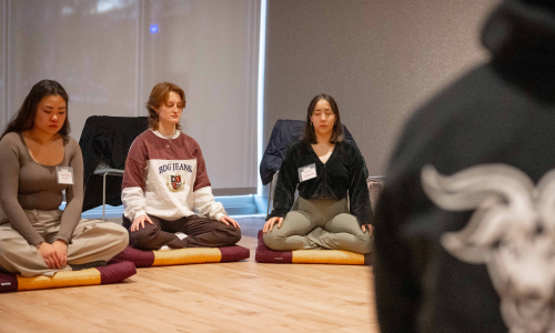 3 wpi students meditating in a sitting position