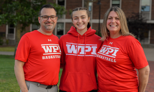 wpi basketball athlete with their 2 parents