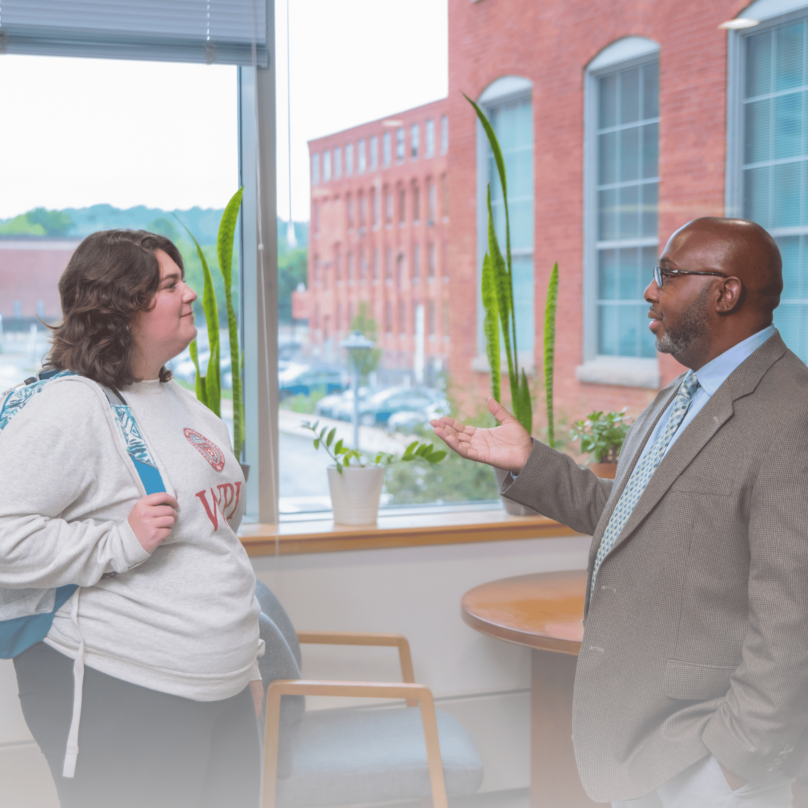 Staff discussing with student
